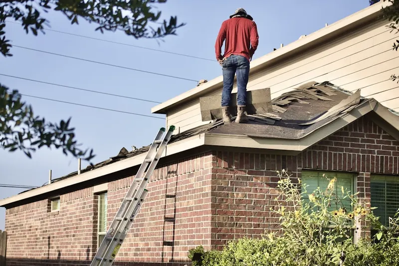 Professional roofer working on a residential roof in Sierra Ridge Estates